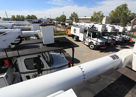 Bucket trucks with aerial lifts for tree trimming